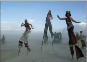  ?? PHOTO SCOTT SADY/THE RENO GAZETTE-JOURNAL VIA AP ?? In this Sept. 2, 2004file photo stilt walkers enjoy a sunset stroll at the Burningman counter culture arts festival in the Black Rock Desert 100miles north east of Reno, NV.