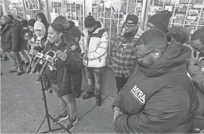  ?? MARK HOFFMAN / MILWAUKEE JOURNAL SENTINEL ?? Shanel Vrontez, a 414Life outreach worker, leads a prayer before a news conference Tuesday in the 3200 block of West Villard Avenue in Milwaukee. On Sunday, a 17-year-old was shot and killed at the location. The event was organized by 414Life, the city’s team of violence interrupte­rs.