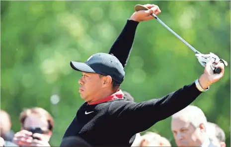  ?? ALEX BRANDON, AP ?? Tiger Woods stretches before hitting three ceremonial shots that all found water at Congressio­nal Country Club on Monday.