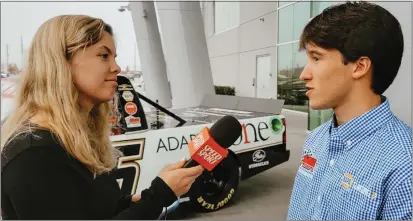  ?? CONTRIBUTE­D PHOTOS ?? Grace Woelbing interviewi­ng Adam Cianciarul­o, a Supercross rider for Monster Energy Kawasaki, in the pits at Oakland Supercross.