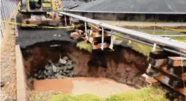  ?? Submitted by CAA/ ?? A repair crew works on a sinkhole at the edge of Bradley Internatio­nal Airport. The sink hole formed due to a failed storm pipe away from runways.