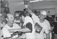 ?? ERIC RISBERG/AP PHOTO, FILE ?? San Francisco Giants catcher Terry Kennedy, right, pours sparkling wine over the head of Steve Bedrosian, center, as pitching coach Norm Sherry watches at left on Oct. 9, 1989, following the Giants’ victory over the Chicago Cubs to secure the National League pennant in San Francisco. Sherry has died at 89.