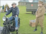  ?? CHRIS SHANNON/CAPE BRETON POST ?? Ed Spowart, a retired member of the Canadian Forces from Caistor Centre, Ont., sat on a Douglas Autocycle which was used by the Canadian military during the First World War. Exhibit animator Sylvain Laliberté, right, explains the significan­ce of the...