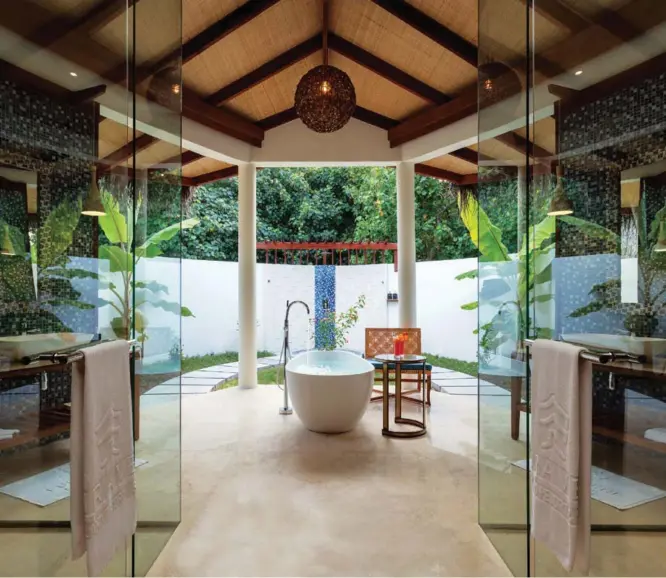  ??  ?? Above: The lush, tropical bathroom in a Dhoni Pool Villa is the ideal way to get island-ready. Previous spread: Furaveri’s pristine beaches and relaxed atmopshere offers plenty of ways to chill out