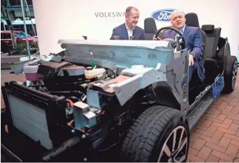  ?? GETTY IMAGES ?? Volkswagen Group CEO Herbert Diess, left, and Fort Motor Co. President and CEO Jim Hackett announce Friday a deeper alliance in Argo AI, which is developing electric and autonomous vehicles.