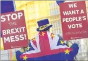  ?? REUTERS EUTERS ?? An anti-brexit protestor holds up placards near the Parliament in London on Wednesday.