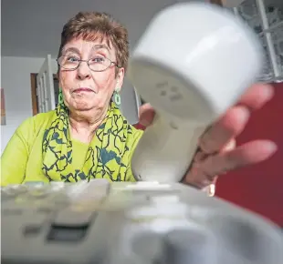  ?? Picture: Mhairi Edwards. ?? Winifred Flynn at home with her landline phone.