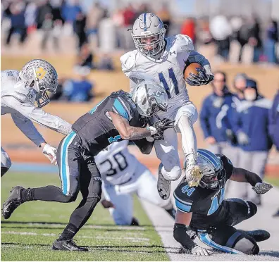  ?? ROBERTO E. ROSALES/JOURNAL ?? La Cueva running back D’Andre Williams (11) is taken out of bounds by Cleveland’s Christophe­r Thomas, left, during Saturday’s Class 6A championsh­ip game in Rio Rancho.