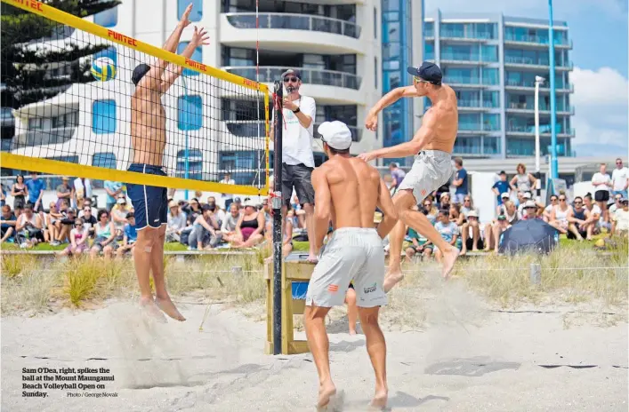  ??  ?? Sam O’dea, right, spikes the ball at the Mount Maunganui Beach Volleyball Open on Sunday.