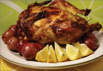  ?? TNS ?? FILL THE PAN: Roast a marinated lemon chicken atop a bed of vegetables adds flavor to the veggies as well.