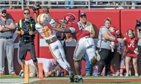  ?? AP PHOTO/VASHA HUNT ?? Tennessee receiver Squirrel White (10) catches a touchdown pass over his shoulder in the end zone as Alabama linebacker Chris Braswell tries to catch up during the first half of Saturday’s game in Tuscaloosa. White’s acrobatic reception held up as a score after a video review.