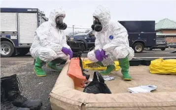  ?? OHIO NATIONAL GUARD VIA AP ?? Ohio National Guard members prepare to assess remaining hazards Tuesday in East Palestine, Ohio, after toxic chemicals from a derailed train were burned. Evacuated residents were cleared to return Wednesday.