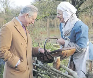  ?? ?? Volunteer Tina Litchfield offers Charles a juicy pear from the Bayleaf Farm garden