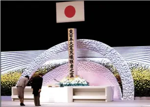  ?? ASSOCIATED PRESS ?? Japan’s Emperor Naruhito (right) and Empress Masako bow Thursday in front of the altar for victims of the March 11, 2011, earthquake and tsunami at the national memorial service in Tokyo.