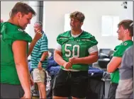  ?? (River Valley Democrat-Gazette/Hank Layton) ?? Alex Welborn (from left), Ethan Hurst and Chasen Thibodeaux of Van Buren visit between photo shoots Tuesday during the River Valley football media day inside the Fellowship of Christian Athletes building in Fort Smith. Visit nwaonline.com/photo for today’s photo gallery.