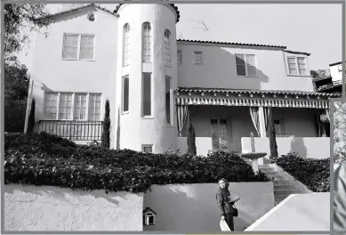  ?? PHOTO BY DENNIS HOPPER ?? Brooke Hayward, left, stands in front of the home she shared with her husband, Dennis Hopper, at 1712 N. Crescent Heights Blvd. in L.A. The years of their marriage, 196169, were a period of bold artistic change in Los Angeles, and the role their house
played as a center for that movement is told in Mark Rozzo’s new book, “Everybody Thought We Were Crazy: Dennis Hopper, Brooke Hayward, and 1960s Los Angeles.”