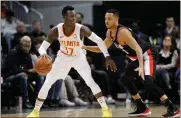  ?? Brett Davis / AP ?? Atlanta point guard Dennis Schroder (17) is defended by Portland guard CJ McCollum (3).