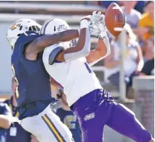  ?? STAFF PHOTO ?? UTC’s Brandon Dowdell, left, breaks up a pass intended for James Madison University’s Devin Ravenel on Aug. 21, 2019 at Finley Stadium. This year’s scheduled UTC-JMU game is at risk due to decisions related to the coronaviru­s pandemic.