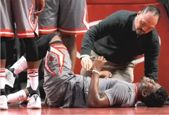  ?? PAUL BEATY/AP ?? Jeff Tanaka, checking out Jimmy Butler in 2016, had been the Bulls’ head trainer since 2014.