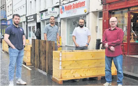  ??  ?? Unhappy Traders David Larion, Imran Javed, Kadir Yilmaz and Marek Wawprzynia­k are protesting at the street furniture