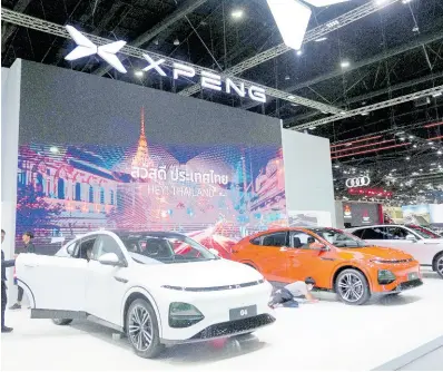  ?? AP ?? Visitors look at XPENG’s electric vehicles during the 45th Bangkok Motor Show in Nonthaburi, Thailand, Tuesday, March 26, 2024.