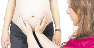  ??  ?? A midwife carrying out antenatal checks
Picture: istock/roger Travis