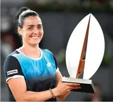  ?? — AFP photo ?? Jabeur celebrates with the trophy after winning against Pegula during the 2022 WTA Tour Madrid Open tennis tournament women’s singles final match at the Caja Magica in Madrid.