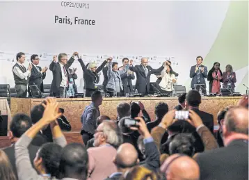  ?? EPA ?? Paris Climate Conference delegates celebrate after the adoption of the COP21 final agreement in Le Bourget on Saturday.