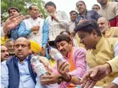  ?? — PTI ?? Delhi BJP president Manoj Tiwari and partymen carry water samples from various parts of Delhi as they stage a protest near chief minister Arvind Kejriwal’s residence in New Delhi on Thursday.