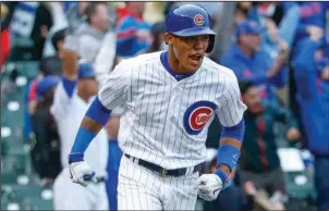  ?? The Associated Press ?? HUSTLE BY RUSSELL: Addison Russell celebrates his three-run homer off Milwaukee reliever Neftali Felix, capping a four-run ninth inning that gives the Chicago Cubs a 7-4 victory Wednesday.