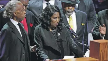  ?? Andrew Nelles Pool Photo ?? ROWVAUGHN WELLS, with the Rev. Al Sharpton, left, and her husband, Rodney Wells, speaks at Wednesday’s funeral service for her son Tyre Nichols at Mississipp­i Boulevard Christian Church in Memphis, Tenn.