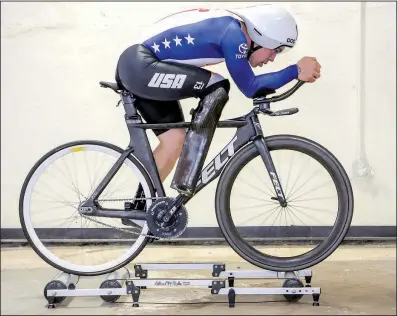  ?? Arkansas Democrat-Gazette/JOHN SYKES JR. ?? Little Rock’s Jason Macom works out on indoor rollers. Macom recently won a paracyclin­g national championsh­ip in the pursuit track event.