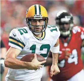  ?? BRETT DAVIS, USA TODAY SPORTS ?? In addition to passing for 246 yards and four touchdowns Sunday, Aaron Rodgers led the Packers with 60 rushing yards against the Falcons.
