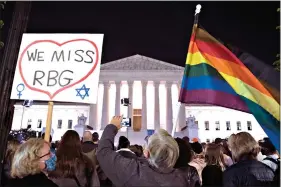  ??  ?? People gather at the Supreme Court to honor the late Justice Ruth Bader Ginsburg on Saturday in Washington. (AP Photo/Cliff Owen)