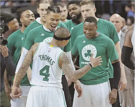  ?? STaffphoTo­byjohnwilc­ox ?? THE STAR: Isaiah Thomas gets a hero’s reception from his teammates after the Celts’ win in Game 2 of their playoff series last night at the Garden.