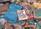  ?? AFP ?? Damaged books are seen on the street after heavy rains flooded a bookstore in Petropolis, Brazil.