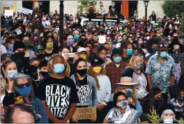  ?? SHMUEL THALER — SANTA CRUZ SENTINEL ?? Hundreds gather, all wearing masks, to listen to Black citizens of Santa Cruz speak their truth at a Juneteenth march and rally in downtown Santa Cruz. The event, organized by Thairie Ritchie, was intended to create a platform to hear from youth, poets, historians, spiritual leaders, mental health advocates and formerly unhoused members of the community on systemic racism in Santa Cruz and stand in solidarity with the Black Lives Matter movement protesting police brutality nationwide.