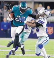  ?? MICHAEL AINSWORTH/ASSOCIATED PRESS ?? Eagles running back LeGarrette Blount (29) breaks a tackle attempt by Dallas’ Xavier Woods. Philadelph­ia improved to 9-1 with the victory, while the Cowboys dropped to 5-5.