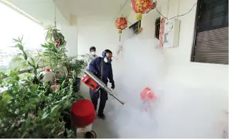  ??  ?? PRECAUTION­S: Workers fogging in the housing estate at Aljunied Crescent in Singapore in this photo by Strait Times on Sunday. (AFP)