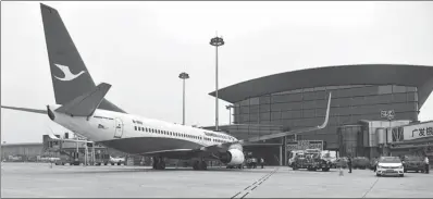  ?? ZHOU WEI / FOR CHINA DAILY ?? Xiamen Airlines’ Flight MF8306 waits for departure in front of the new Terminal 2 of Guangzhou Baiyun Internatio­nal Airport in Guangdong province on Thursday.