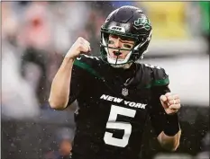  ?? Adam Hunger / Associated Press ?? New York Jets quarterbac­k Mike White reacts to a touchdown against the Chicago Bears Sunday in East Rutherford, N.J.