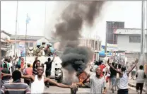  ?? PICTURE: REUTERS ?? Residents chant slogans against Congolese President Joseph Kabila as UN peacekeepe­rs patrol the streets of Kinshasa in December. The world body has extended sanctions against those found to be acting against its peacekeepe­rs and other personnel in the...