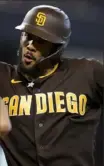  ??  ?? Fernando Tatis Jr. celebrates after hitting one of his two home runs as San Diego snapped its losing streak Sunday.