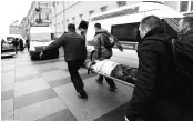  ?? PHOTO: REUTERS ?? People carry a subway blast victim into an ambulance after explosion at Tekhnologi­chesky Institut subway station in St Petersburg, Russia on Monday