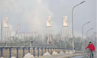 ?? ?? Chimeneas expulsando humo en una central térmica en las afueras de Pekín (China comunista).