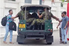  ?? — AFP ?? Sri Lankan Police Special Task Force (STF) soldiers leave the prime minister’s official residence in Colombo on Thursday.