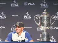  ?? Jamie Squire / Getty Images ?? Brooks Koepka sits alongside the Wanamaker Trophy as he speaks to the media on Sunday.