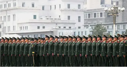  ?? — AFP ?? Standing ready: Chinese paramilita­ry policemen stand in formation at Tiananmen Square after attending a ceremony to commemorat­e the 90th anniversar­y of the founding of the People’s Liberation Army at the Great Hall of the People in Beijing.