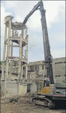  ?? SOURCED ?? The highreach jaw crushing technology that will be used to raze old buildings was tested during the demolishin­g of an old water tank at the airport.