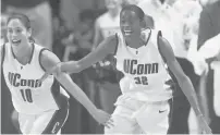  ?? FILE ?? Swin Cash, right, and Sue Bird celebrate a UConn tournament win in 2000. Cash was officially inducted into the Hall of Fame on Saturday.